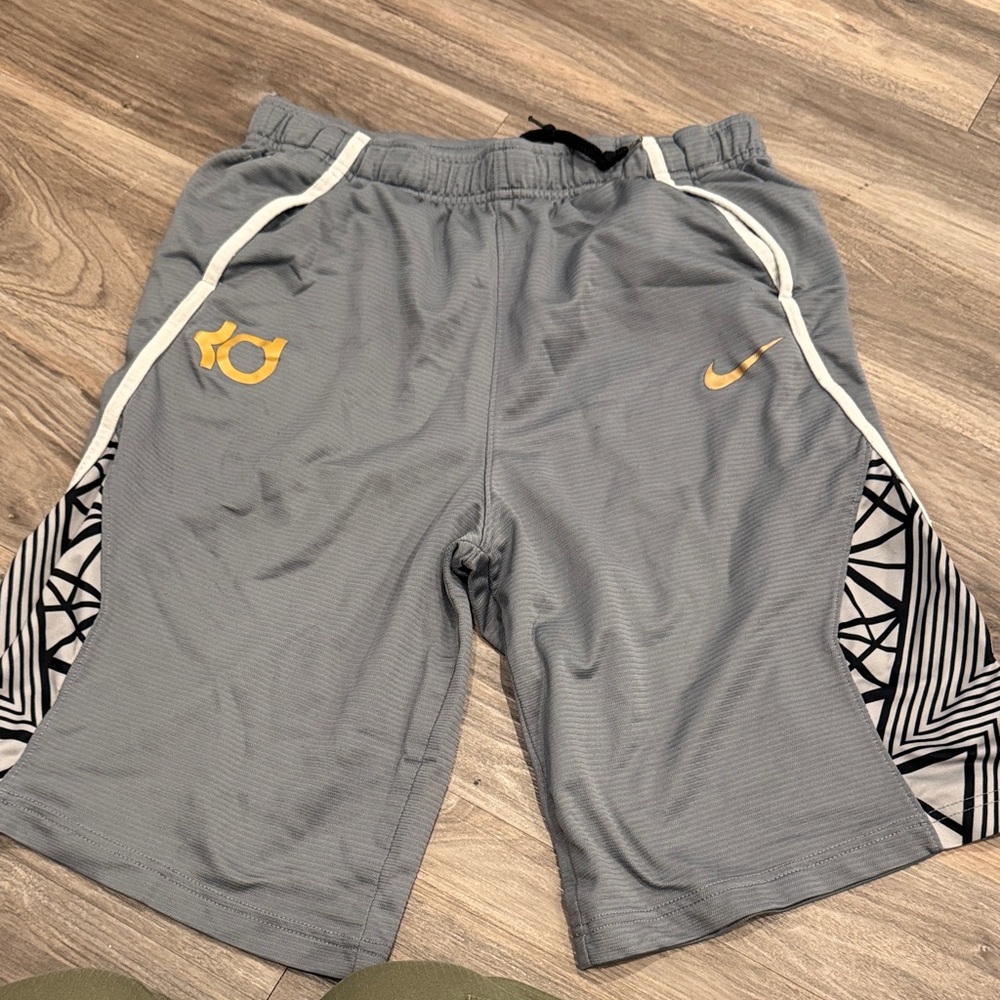 Nike Gray Athletic Shorts with Gold Accents